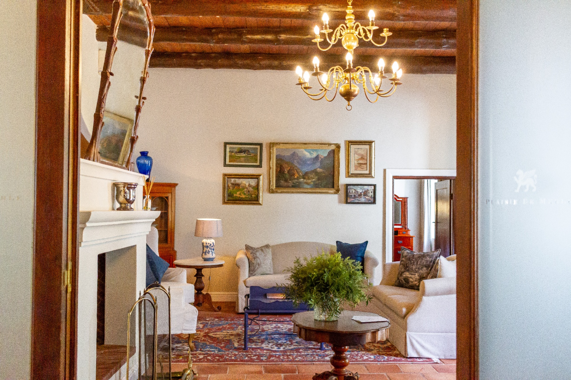 Manor Suite lounge with chandelier and fireplace