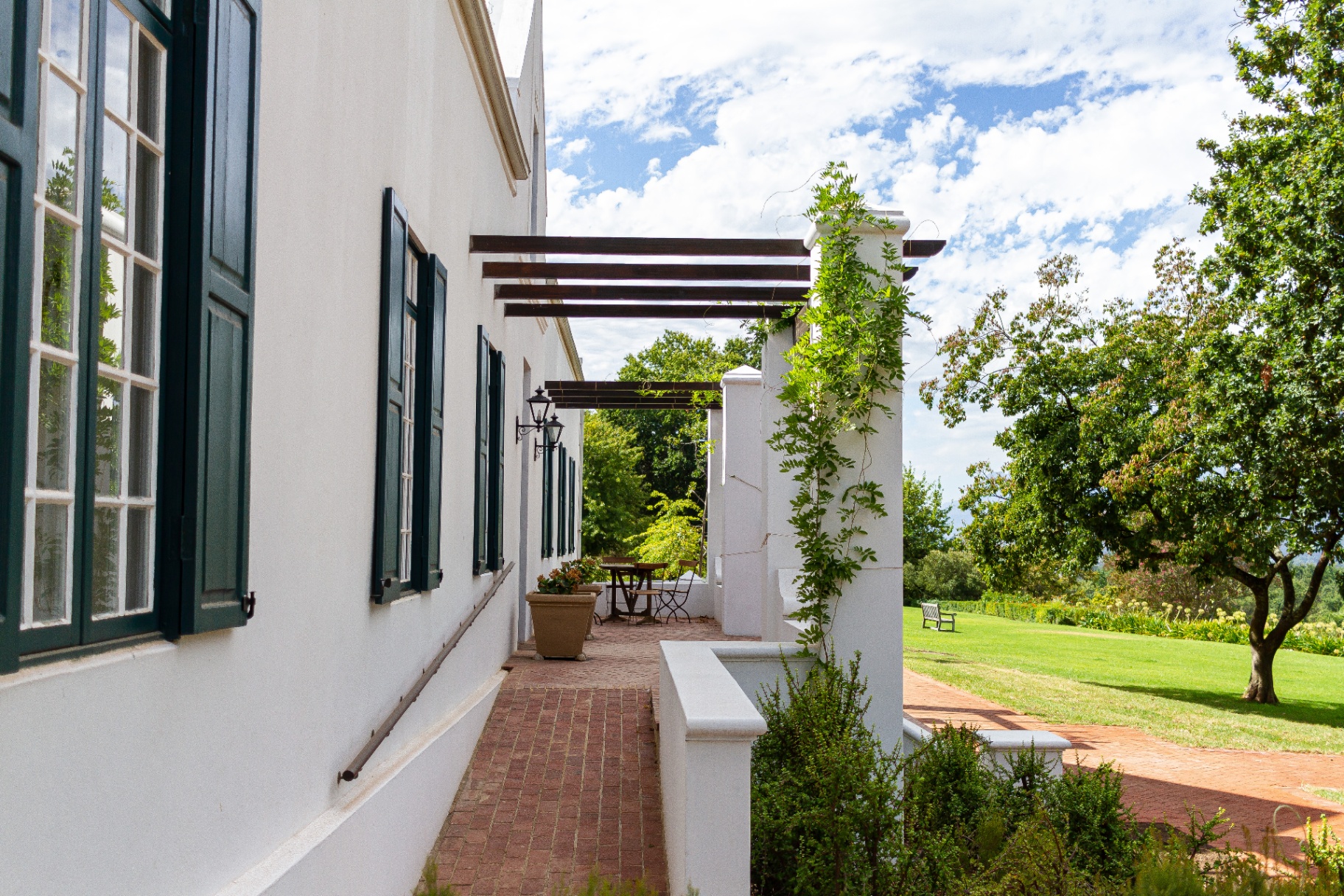Lady Grey Suite covered veranda with shutters and garden outlook