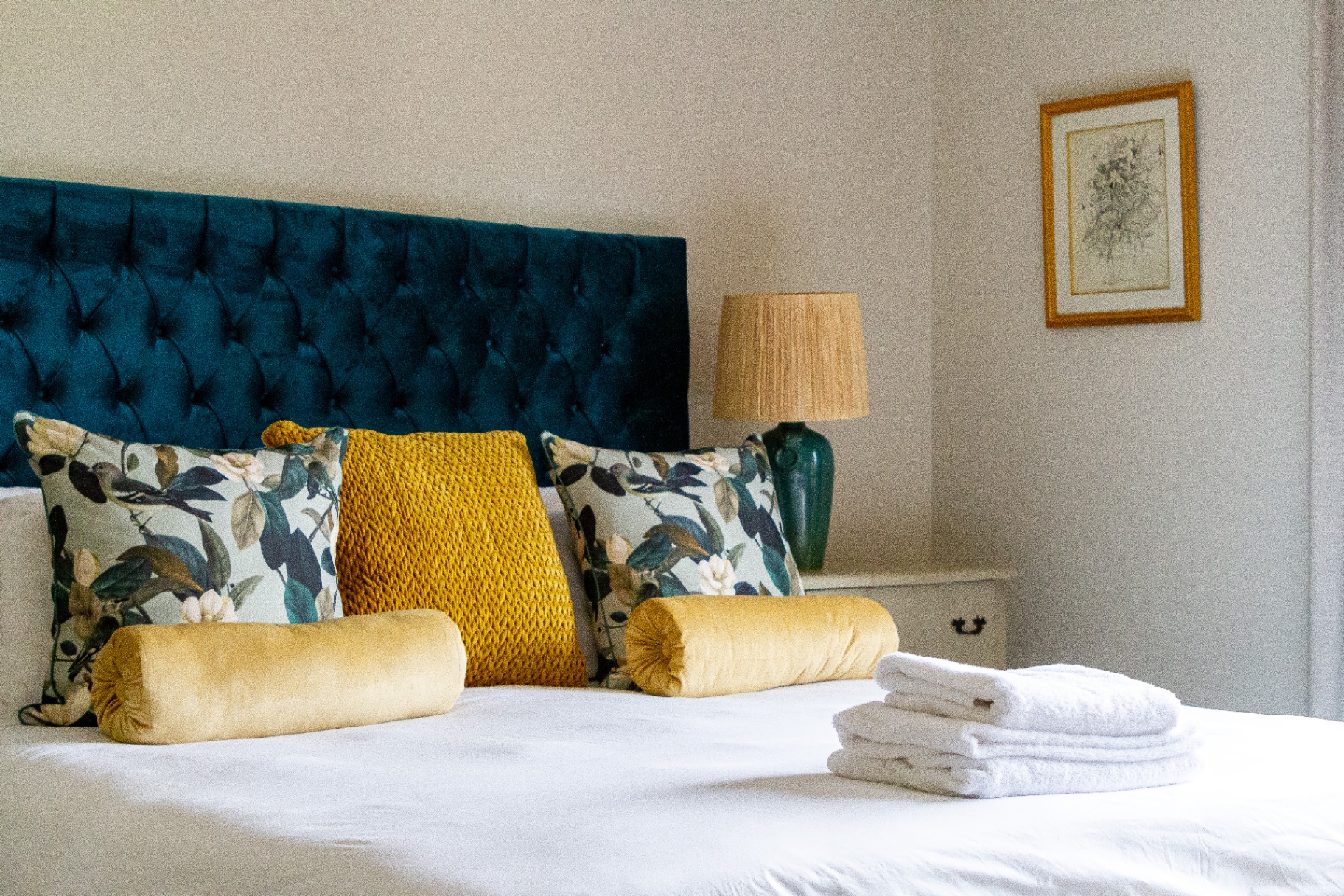 Merle Manor House king bedroom with blue velvet headboard