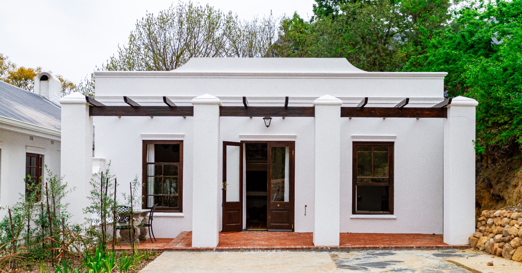 Merle Cottage exterior with Cape Dutch gable and pergola entrance