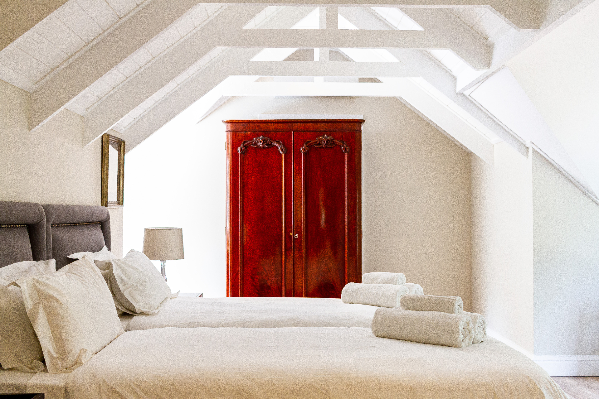 Lady Grey Suite loft bedroom with vaulted ceiling and antique wardrobe