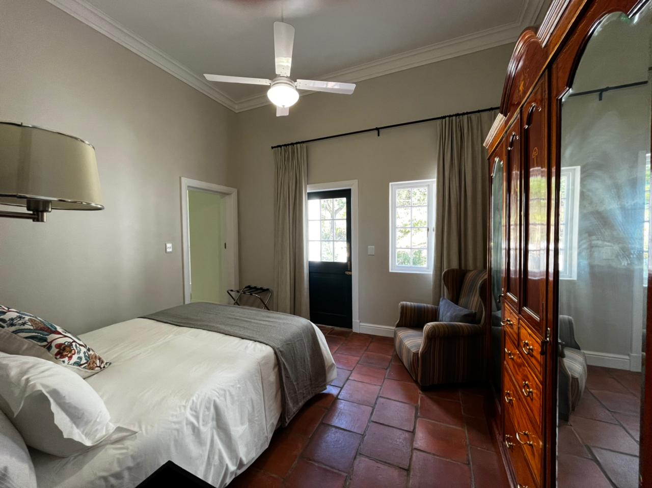 Old Mill Suite bedroom with garden door and terracotta floors
