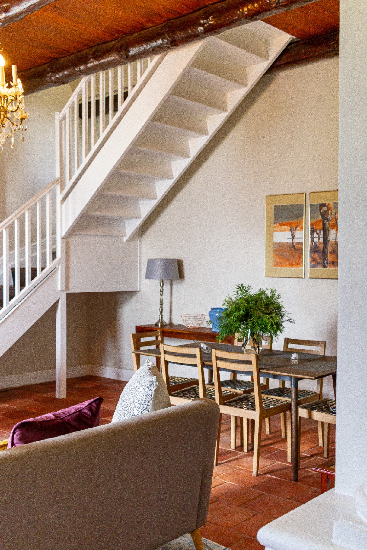 Old Mill Suite open-plan lounge with staircase to loft bedroom
