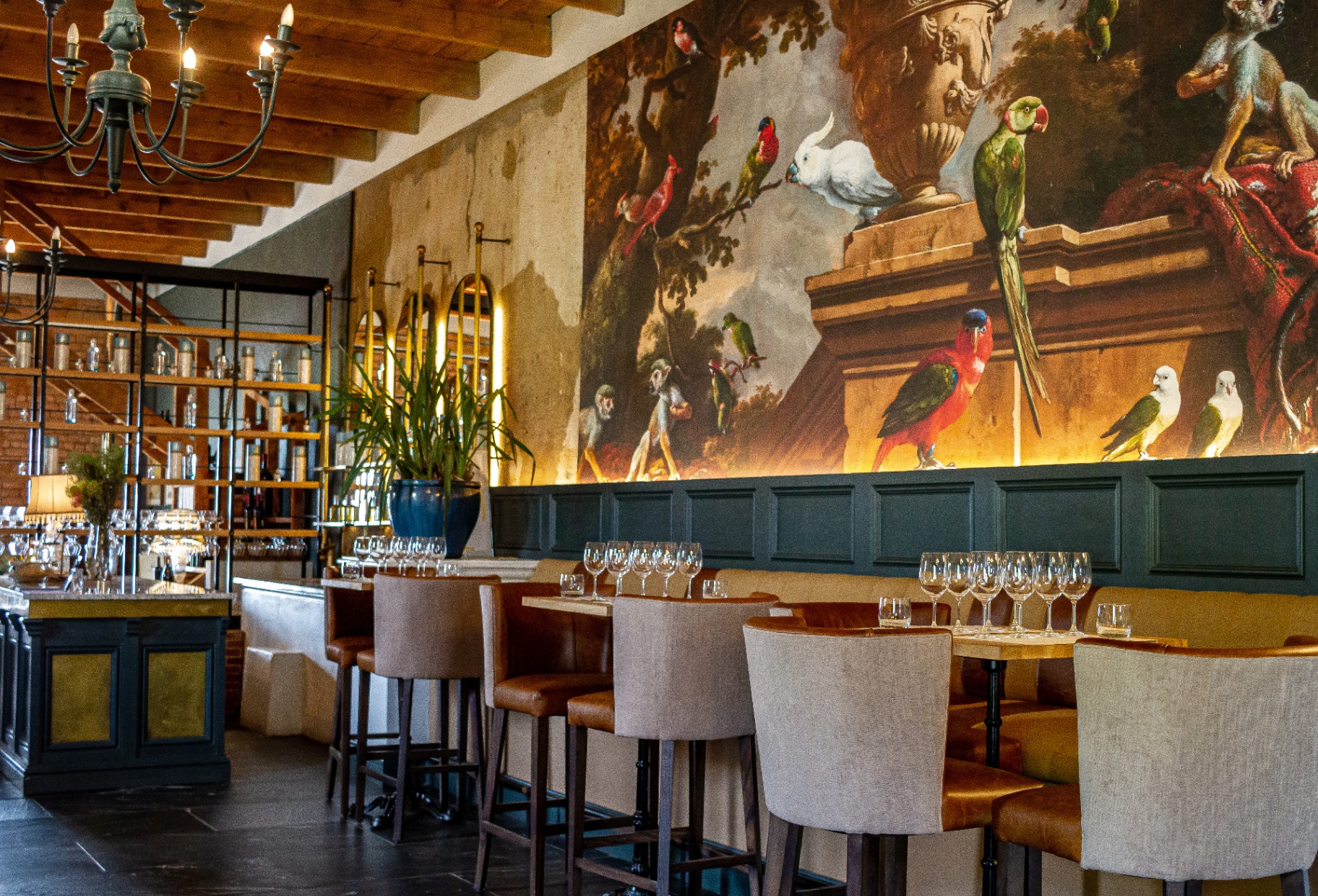 Plaisir tasting room interior with mural, chandeliers and bar seating