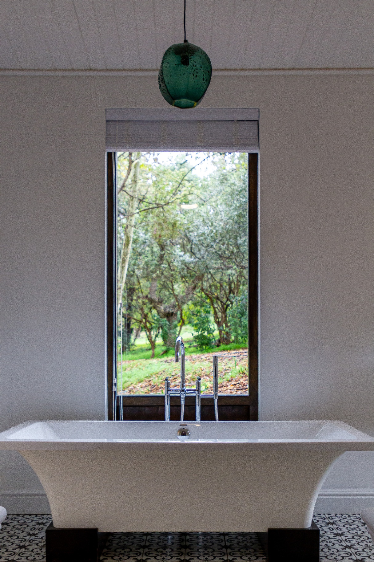 Forest Cottage bathroom with freestanding bath and forest view