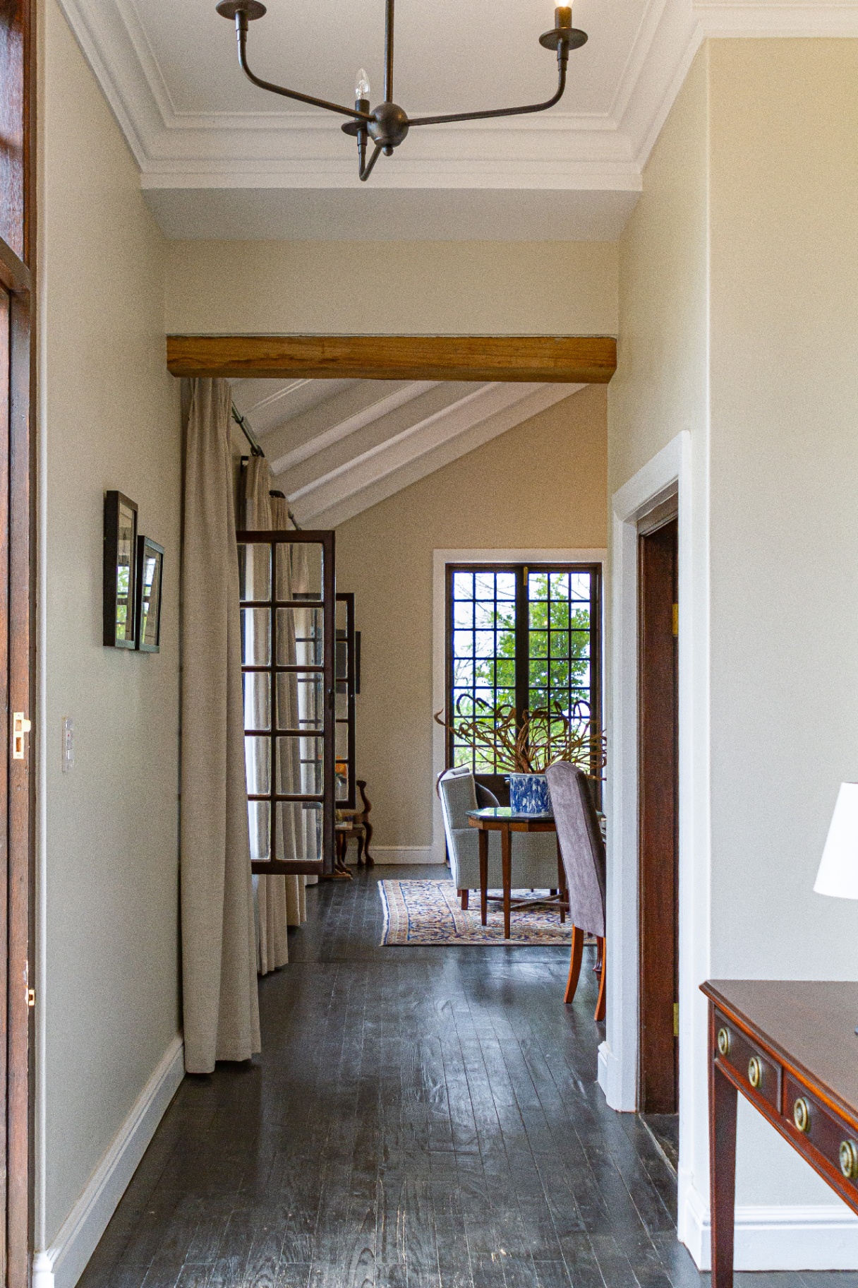 Merle Manor House hallway with vaulted ceiling and dark wood floors