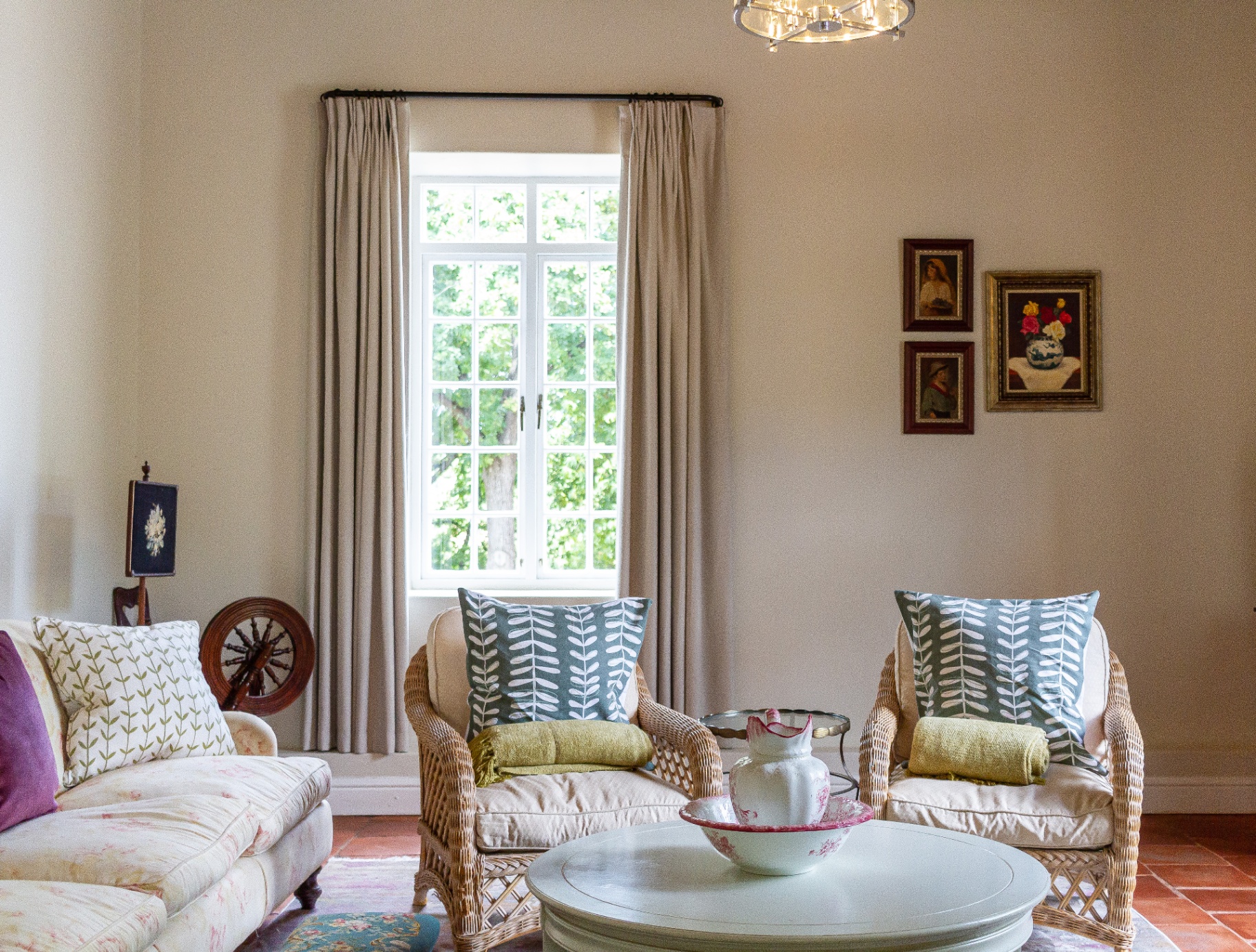 Lady Grey Suite lounge with antique spinning wheel and tall window
