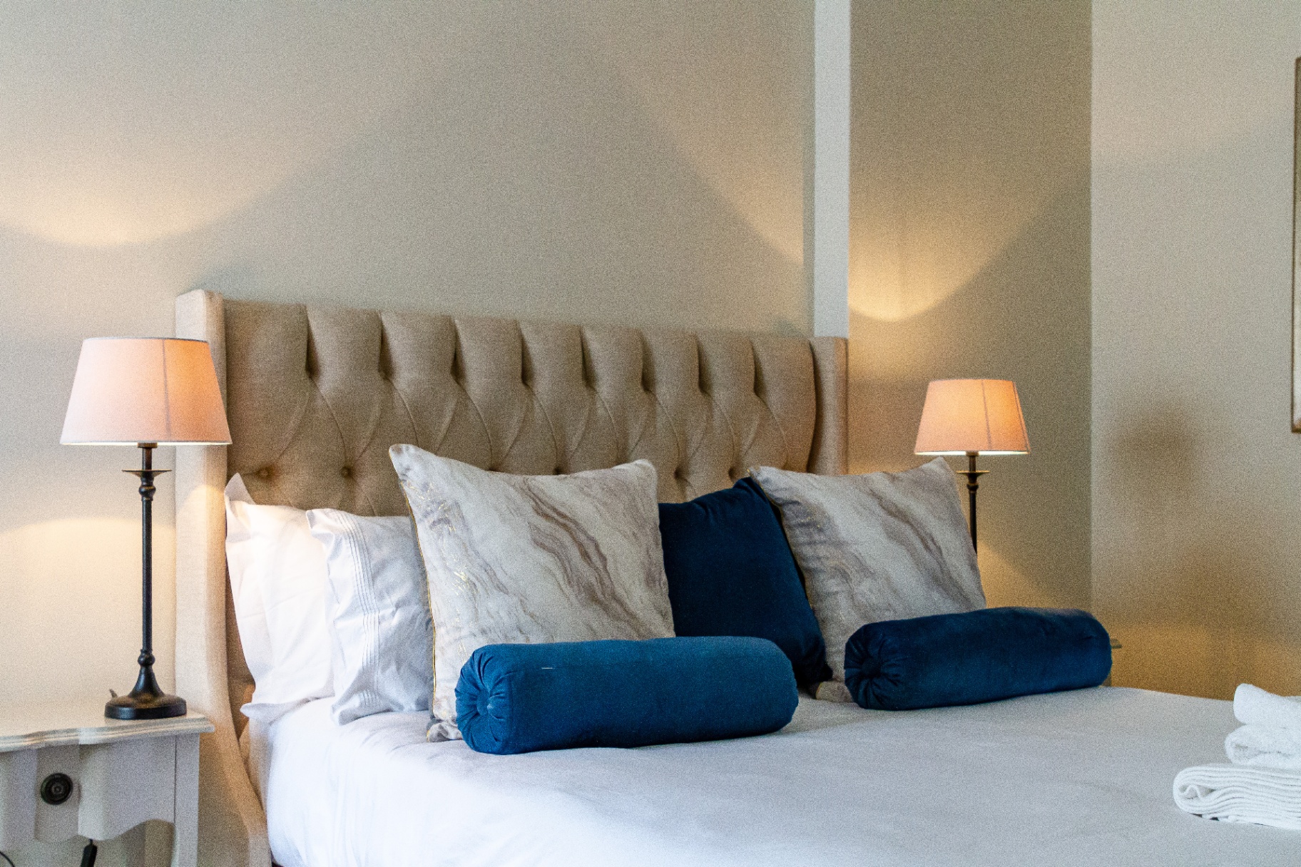 Merle Manor House queen bedroom with tufted headboard