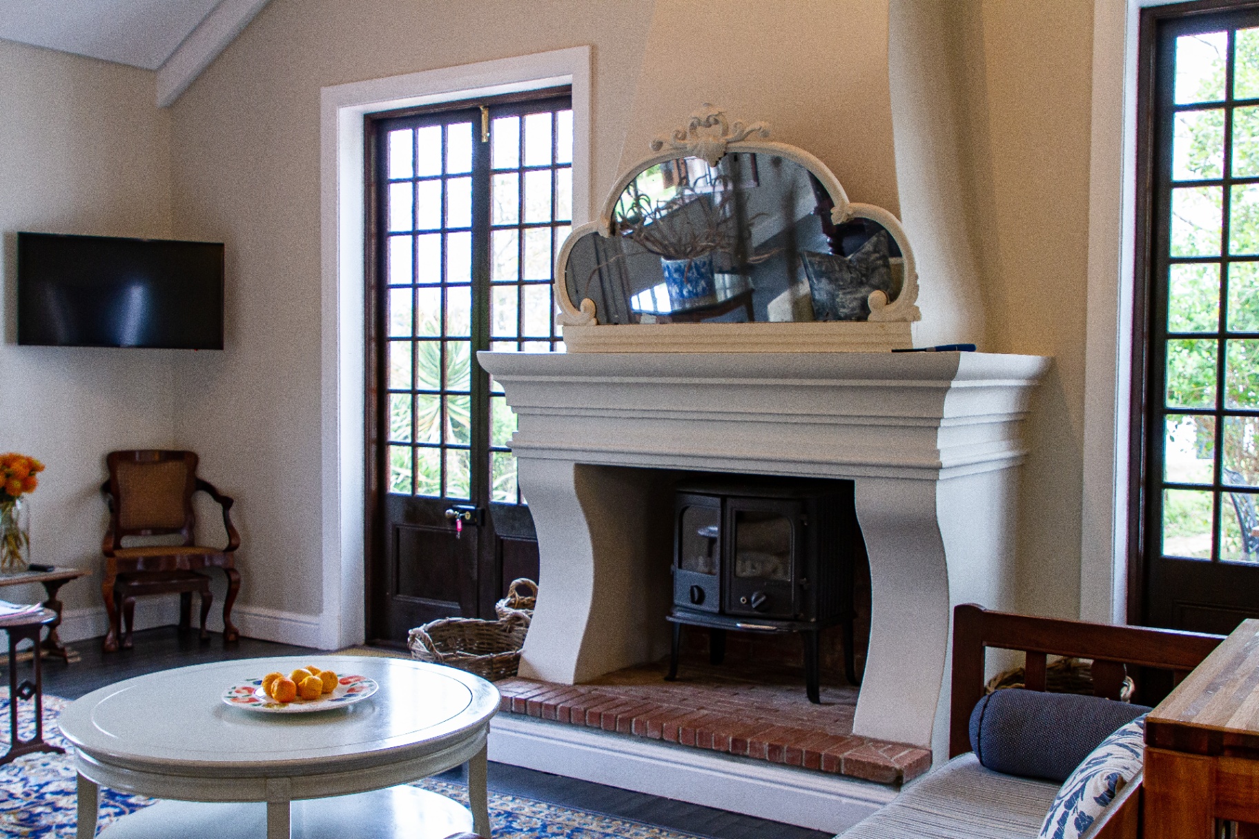 Merle Manor House lounge with grand fireplace and wood stove