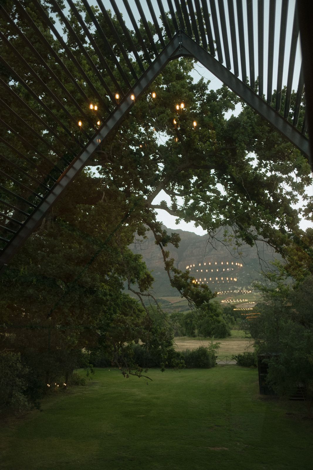 View from inside the venue framing the lawn, oaks and mountain beyond
