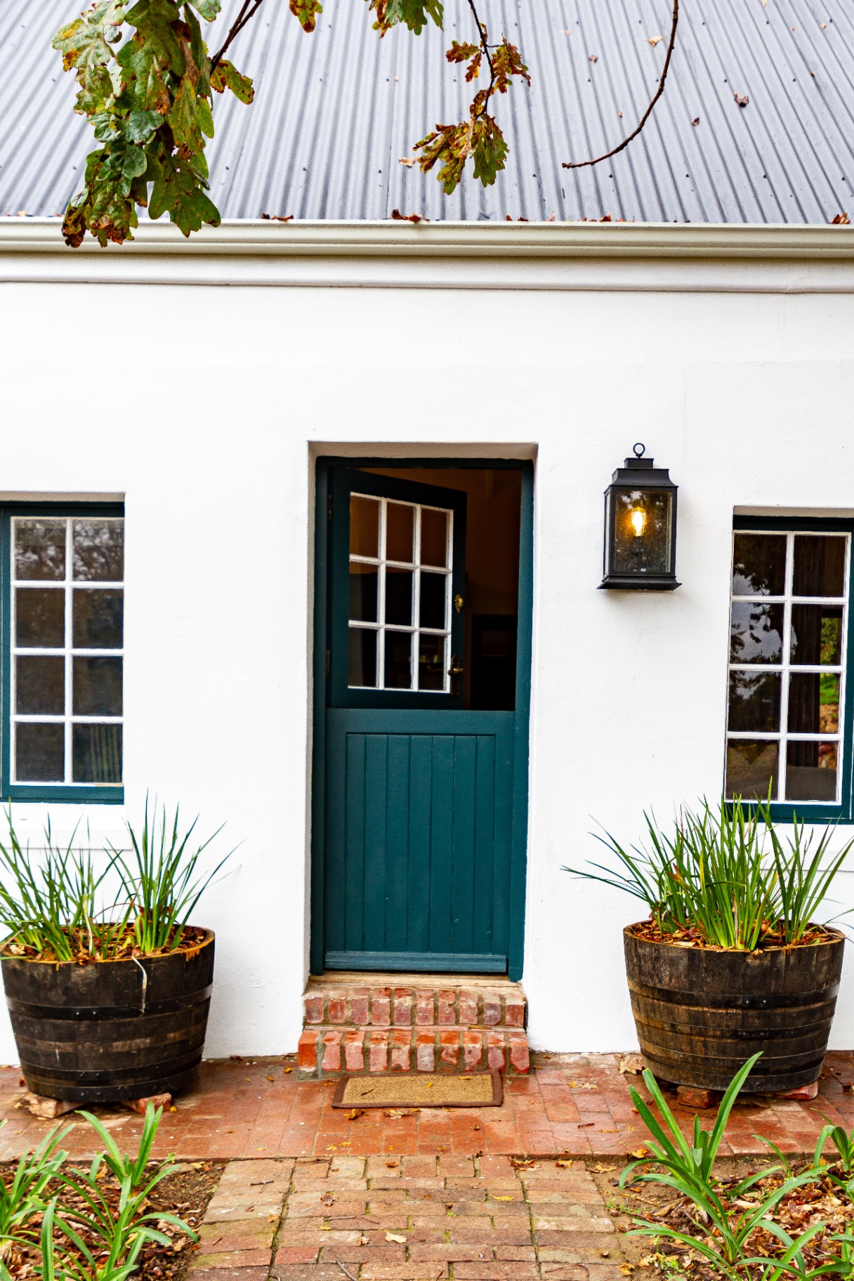 Forest Cottage front door with stable door and barrel planters