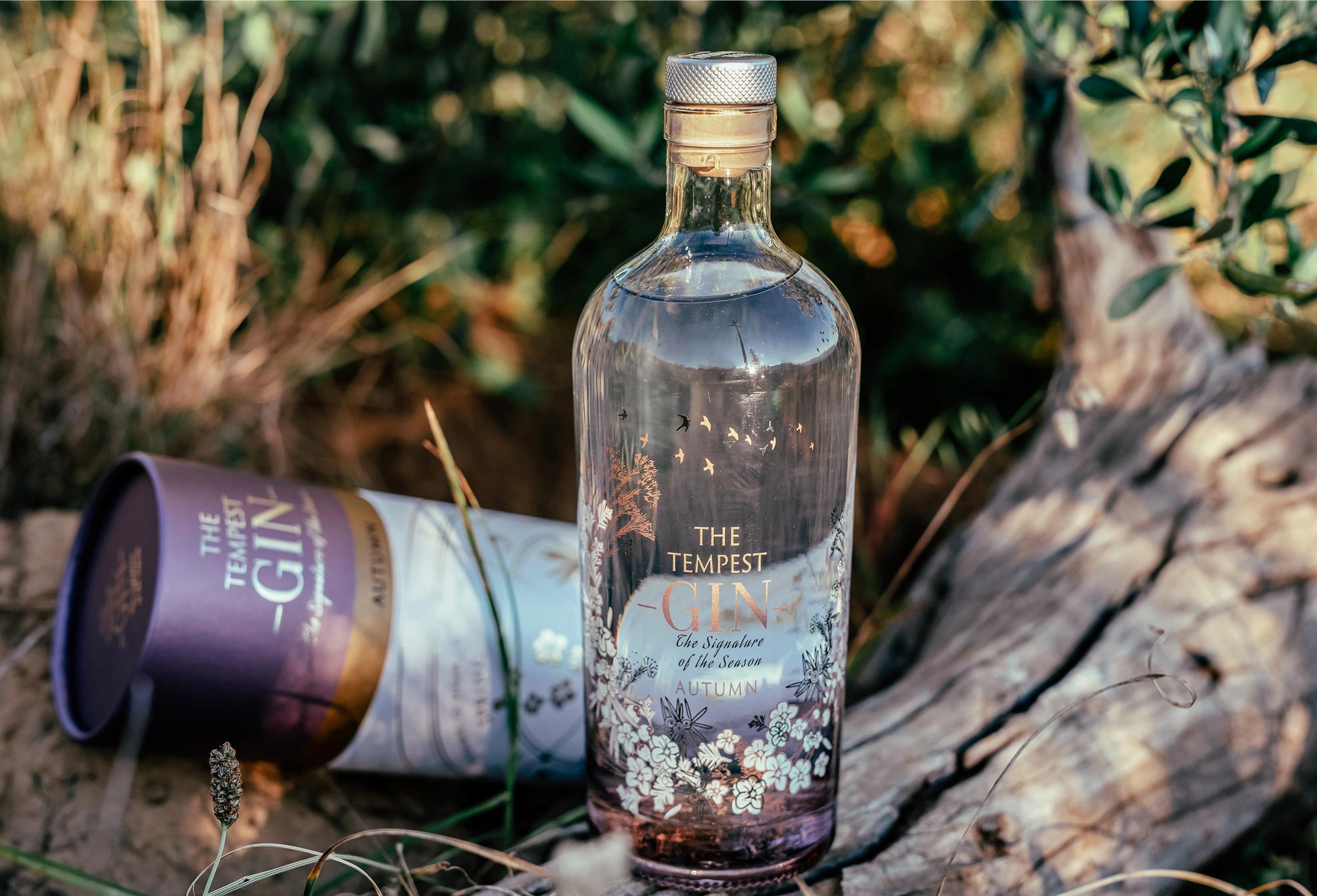 The Tempest Gin Autumn bottle resting on fynbos-covered ground