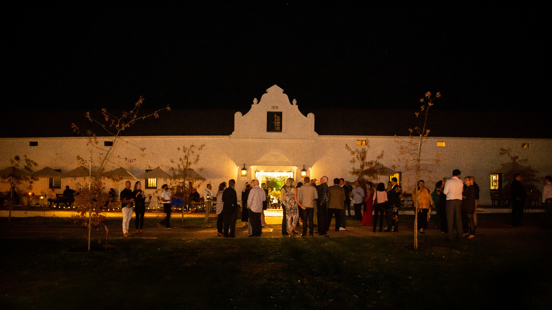 Evening private event gathering outside the historic manor courtyard